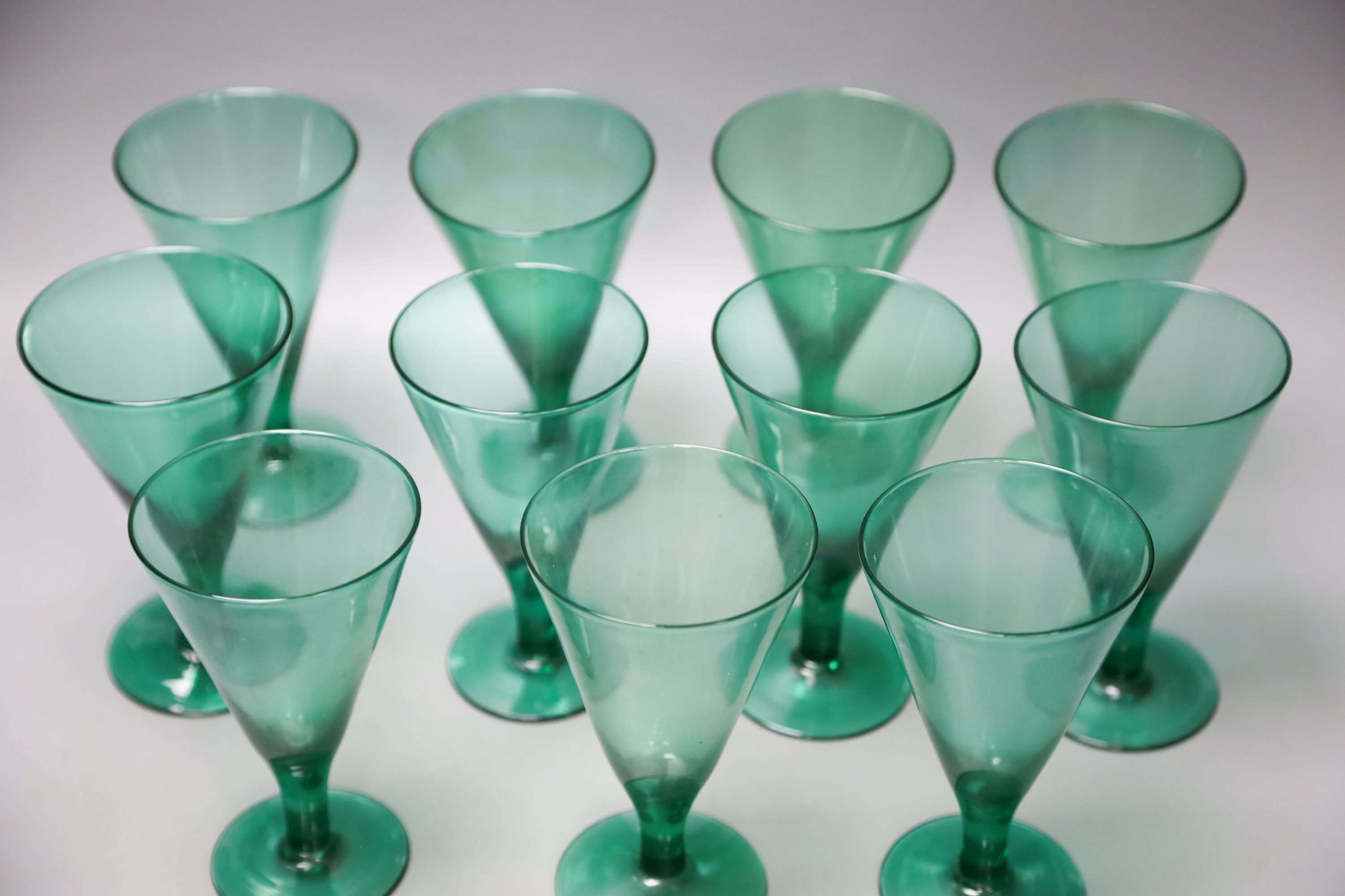 Eleven green wine glasses